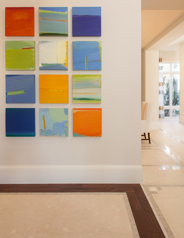 Inspiration for a mid-sized transitional hallway in Miami with white walls, limestone floors and multi-coloured floor.