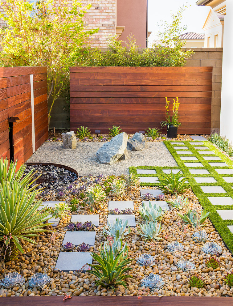 Design ideas for a contemporary backyard garden in Orange County with concrete pavers and with privacy feature.