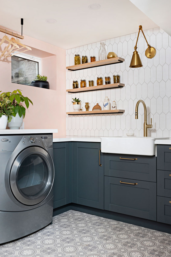 Photo of a country laundry room in Toronto with a farmhouse sink, shaker cabinets, blue cabinets, quartz benchtops, linoleum floors, a side-by-side washer and dryer, grey floor and white benchtop.