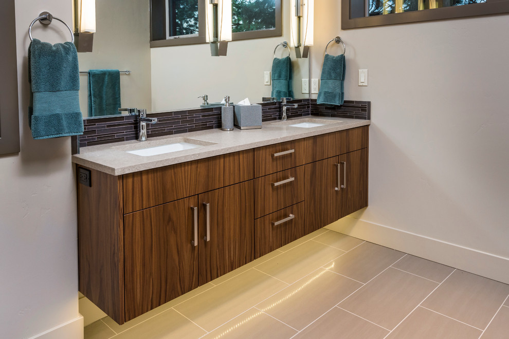 Inspiration for a large contemporary master bathroom in Portland with an undermount sink, flat-panel cabinets, dark wood cabinets, engineered quartz benchtops, a corner shower, a one-piece toilet, brown tile, mosaic tile, grey walls and porcelain floors.