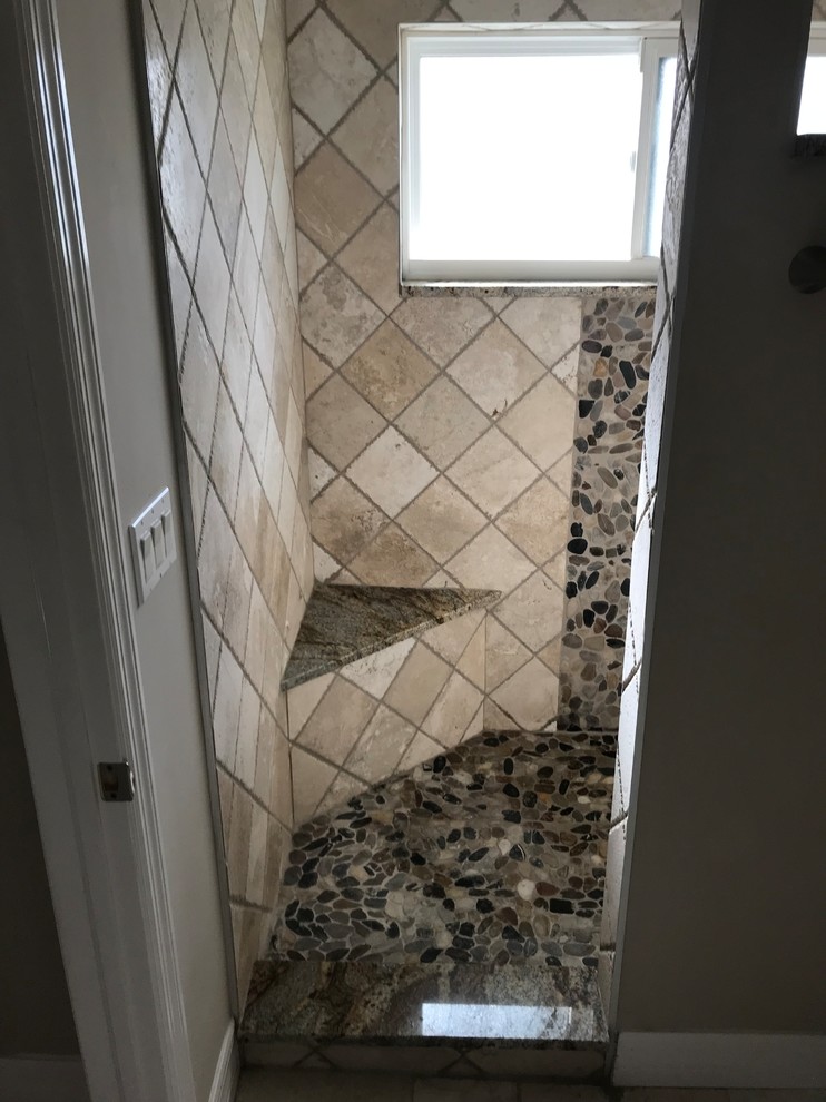 Inspiration for a mid-sized traditional master bathroom in Miami with recessed-panel cabinets, white cabinets, an open shower, a two-piece toilet, beige tile, travertine, beige walls, pebble tile floors, an undermount sink, granite benchtops, an open shower and brown benchtops.