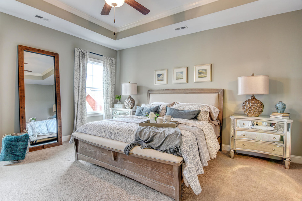 This is an example of a large transitional master bedroom in Other with carpet, no fireplace, beige floor and grey walls.