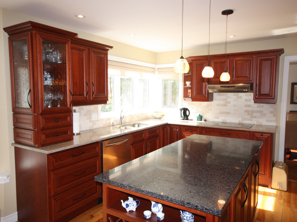 Mid-sized transitional u-shaped medium tone wood floor and brown floor open concept kitchen photo with raised-panel cabinets, red cabinets, granite countertops, beige backsplash, ceramic backsplash, stainless steel appliances, an island and black countertops