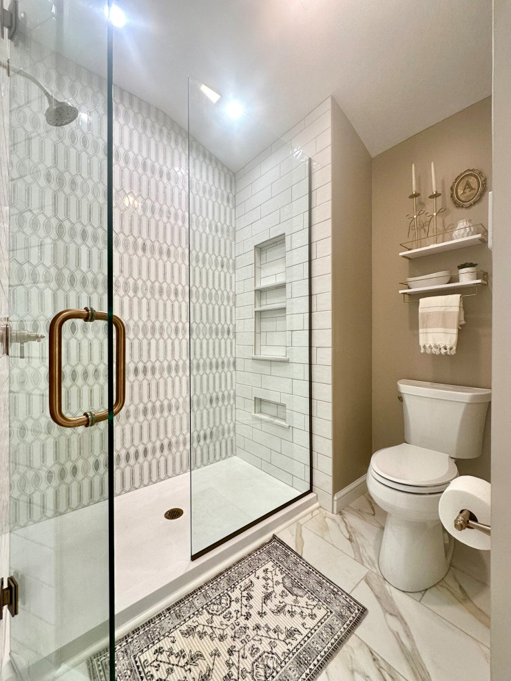 Example of a mid-sized transitional master white tile and marble tile porcelain tile, white floor, double-sink and wainscoting freestanding bathtub design with recessed-panel cabinets, white cabinets, a two-piece toilet, brown walls, an undermount sink, quartz countertops, a hinged shower door, white countertops and a built-in vanity