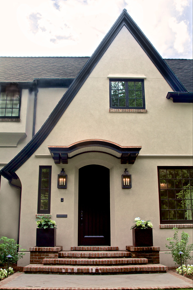 Design ideas for a large traditional three-storey stucco beige house exterior in Portland with a gable roof and a shingle roof.