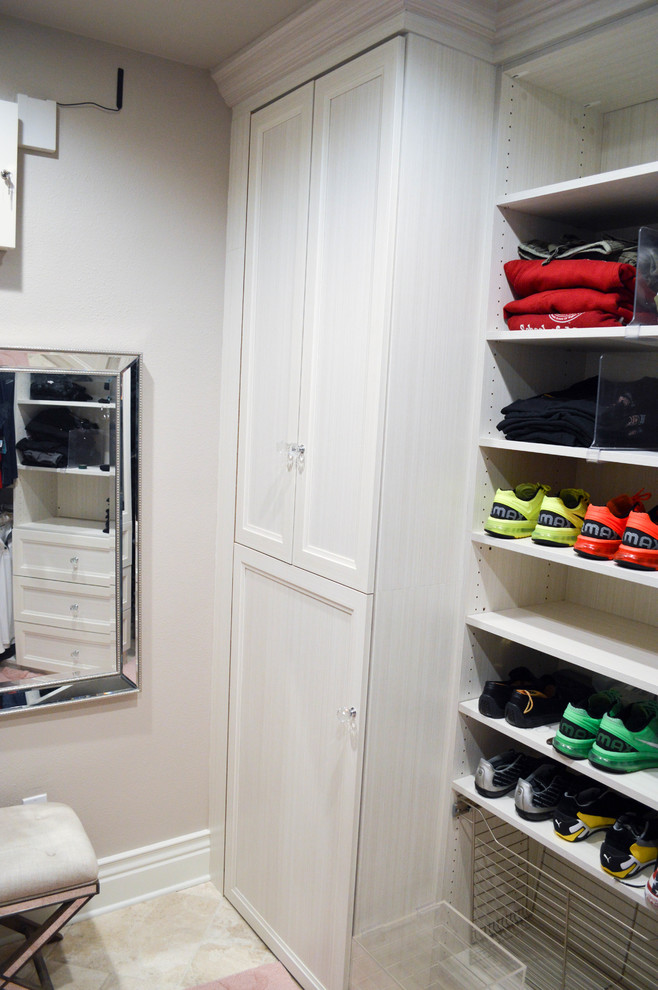 Photo of an expansive transitional men's walk-in wardrobe in Tampa with recessed-panel cabinets, white cabinets, travertine floors and beige floor.