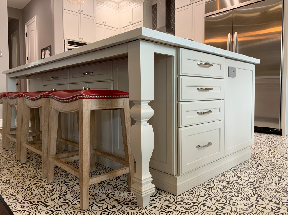 Kitchen - transitional l-shaped porcelain tile and multicolored floor kitchen idea in Houston with a farmhouse sink, recessed-panel cabinets, white cabinets, quartz countertops, gray backsplash, ceramic backsplash, stainless steel appliances, an island and white countertops