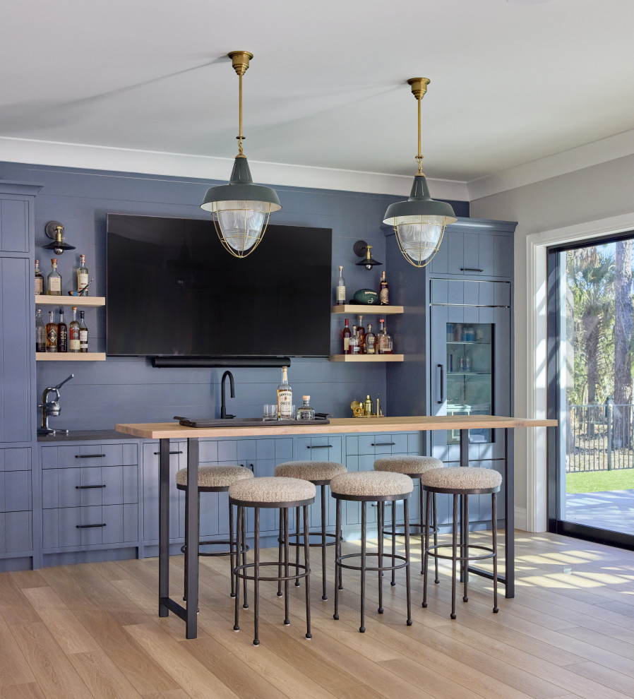 2 Chicks Happy Family Home - Golf Lounge Bar with Slate Blue Cabinets and Brass Dome Pendants. A custom home bar at a Ponte Vedra Beach new home by 2 Chicks Design Co. Slate-blue custom cabinetry, brass dome pendants, dark counters, along with a bar height table and stools, deliver an entertaining space that invites everyone to gather.
Tags: Outdoor Kitchen, Summer Kitchen, Blue Cabinets, Brass Pendants, Outdoor Bar, Coastal Outdoor Kitchen