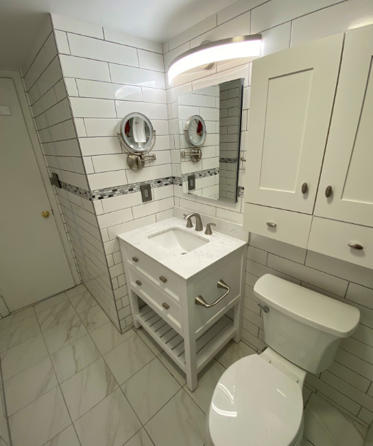 Inspiration for a small transitional 3/4 white tile and subway tile ceramic tile, white floor and single-sink alcove bathtub remodel with furniture-like cabinets, white cabinets, a two-piece toilet, white walls, an undermount sink, quartz countertops, white countertops, a niche and a freestanding vanity