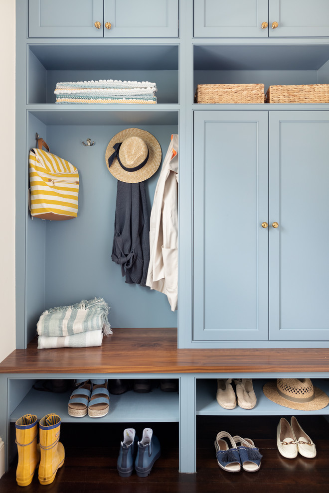 Inspiration for a beach style mudroom in Boston with dark hardwood floors and blue walls.