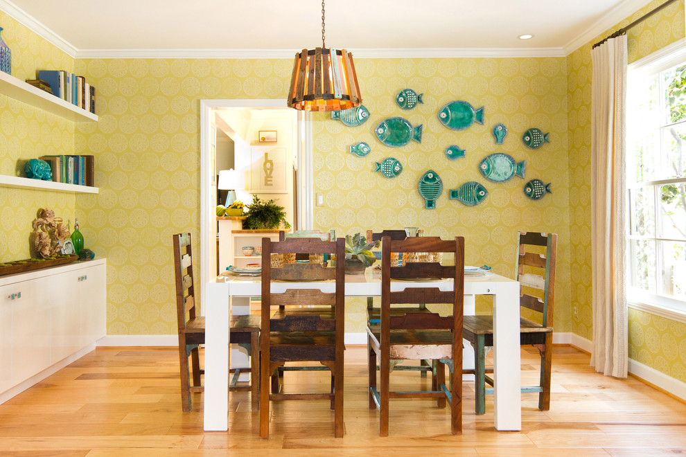 Inspiration for a beach style separate dining room in Los Angeles with green walls and light hardwood floors.