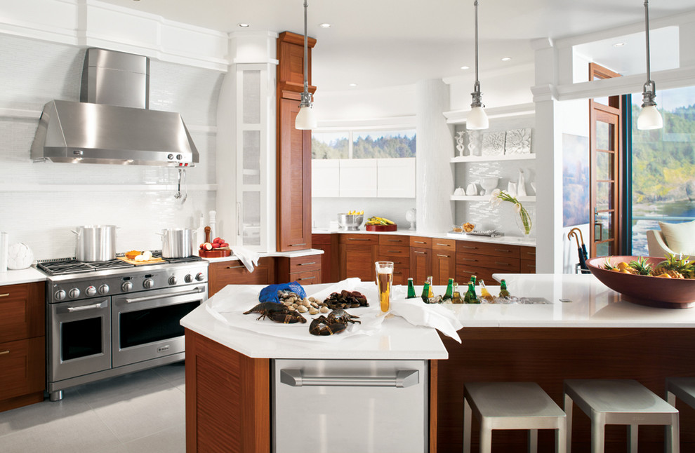 Large contemporary u-shaped kitchen in New York with medium wood cabinets, marble benchtops, white splashback, glass tile splashback, stainless steel appliances, with island, a drop-in sink, flat-panel cabinets, cement tiles and grey floor.