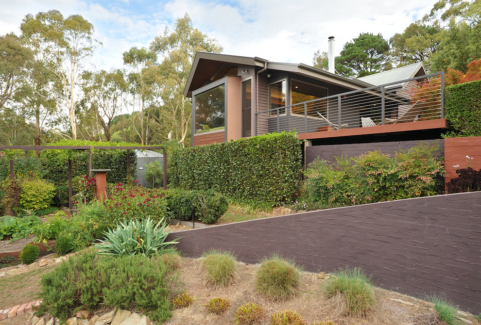 Design ideas for an eclectic one-storey exterior in Melbourne with wood siding.