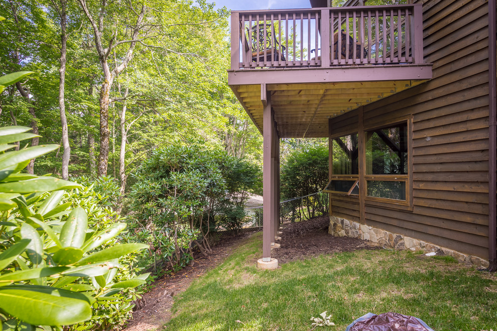 Large mountain style backyard deck photo in Charlotte with a fire pit and no cover