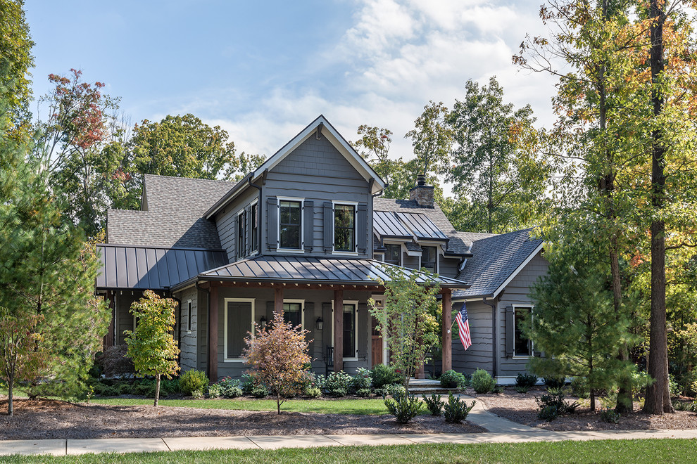Example of a large mountain style gray two-story mixed siding exterior home design