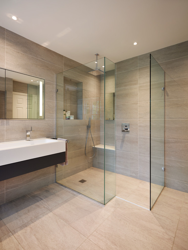 Inspiration for a large contemporary master bathroom in Surrey with an integrated sink, flat-panel cabinets, white cabinets, engineered quartz benchtops, an alcove tub, an alcove shower, a wall-mount toilet, gray tile, porcelain tile, grey walls and ceramic floors.