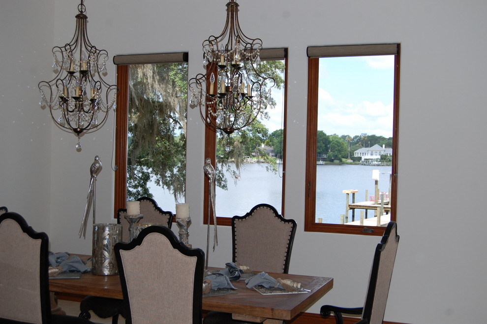 Photo of a mid-sized mediterranean dining room in Miami with white walls.