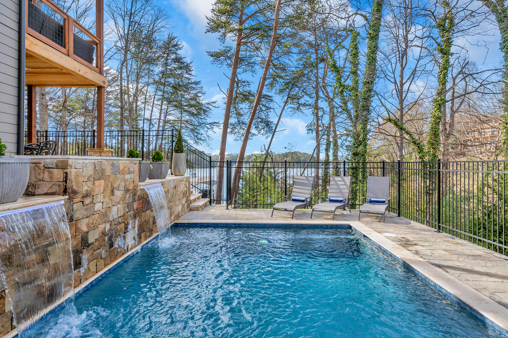 Design ideas for a contemporary side yard rectangular lap pool in Atlanta with a water feature.