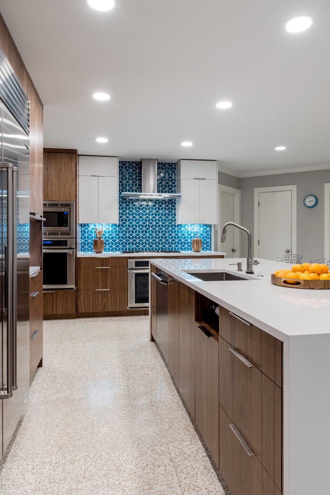 Mid-sized midcentury l-shaped eat-in kitchen in Austin with medium wood cabinets, blue splashback, ceramic splashback, stainless steel appliances, with island, beige floor and grey benchtop.