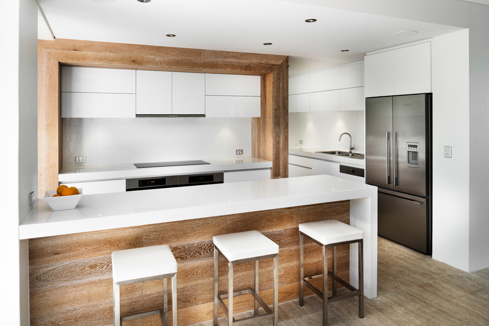 Inspiration for a contemporary kitchen in Perth with flat-panel cabinets, white cabinets, white splashback, subway tile splashback and stainless steel appliances.