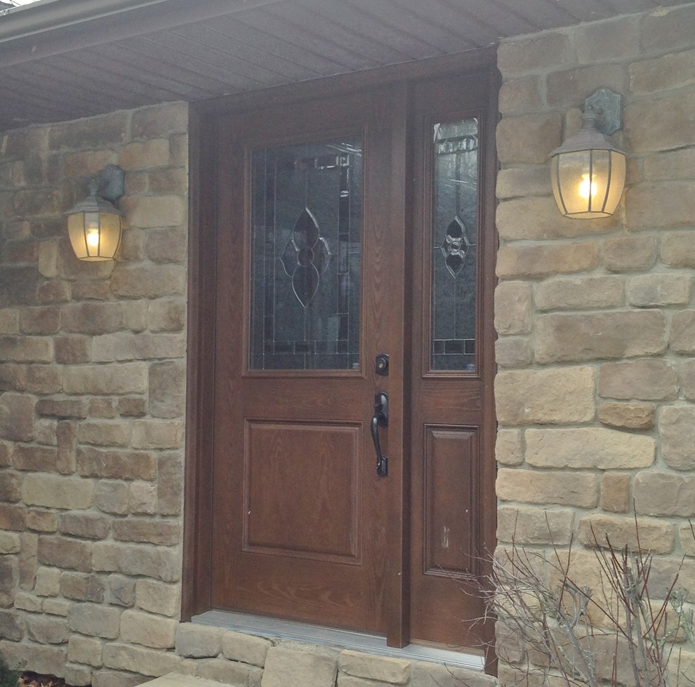 Photo of a traditional front door in Other with a brown front door.