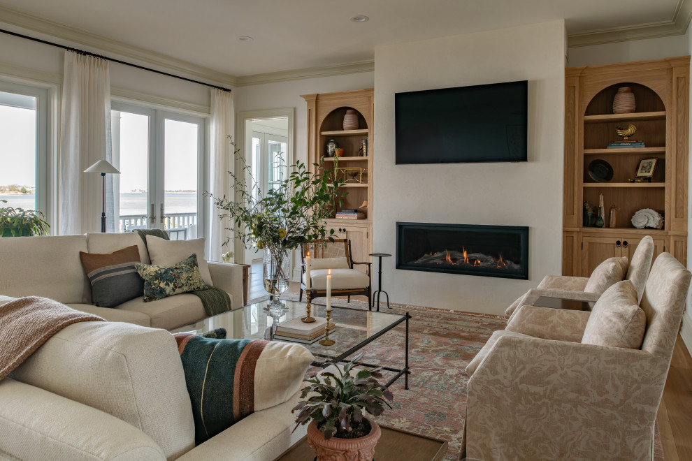 Inspiration for a timeless medium tone wood floor and brown floor living room remodel in New York with beige walls, a ribbon fireplace and a wall-mounted tv