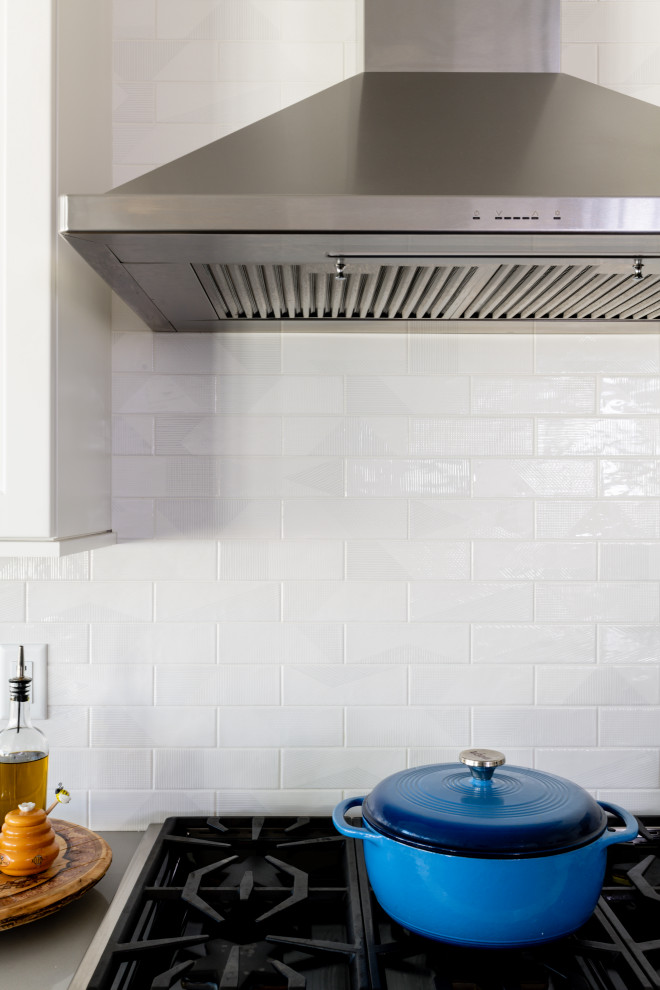 Example of a transitional kitchen design in Providence with an undermount sink, shaker cabinets, quartzite countertops, subway tile backsplash and an island
