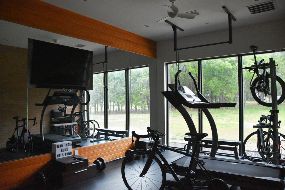 Design ideas for a modern home weight room in Dallas with multi-coloured walls and black floor.