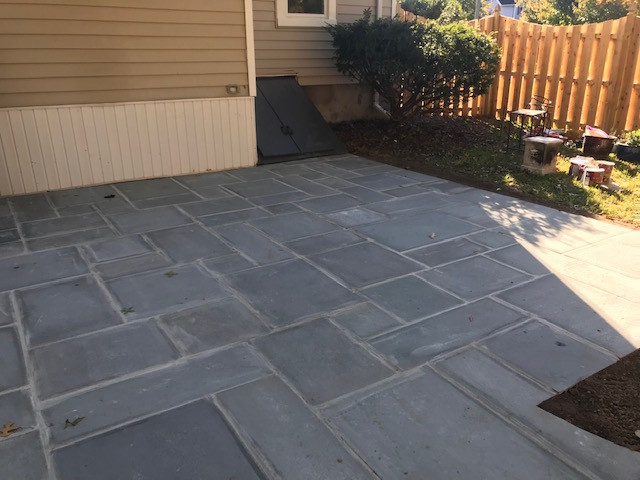 Bluestone patio wet lay with walkway and landscape