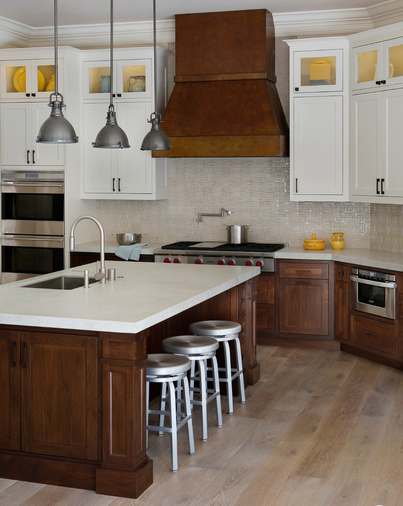 Photo of a transitional l-shaped eat-in kitchen in San Francisco with an undermount sink, shaker cabinets, dark wood cabinets and stainless steel appliances.