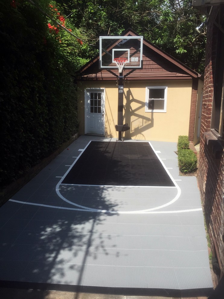 Photo of a small modern backyard partial sun outdoor sport court in New York with with outdoor playset.