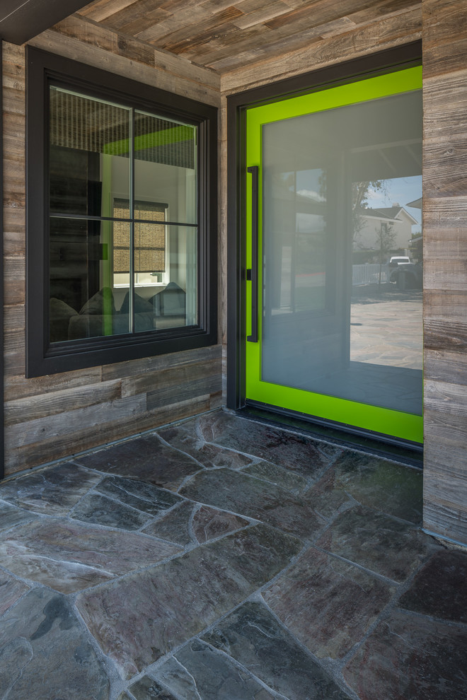 Inspiration for a mid-sized contemporary foyer in Orange County with slate floors, a single front door, a green front door and grey floor.