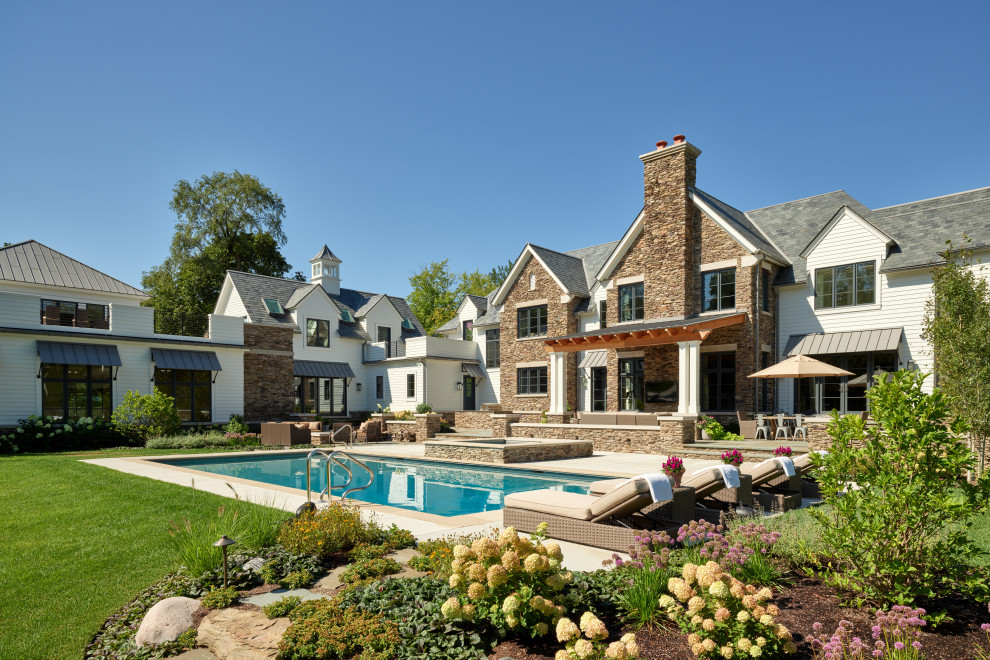 Inspiration for a country white house exterior in Chicago with a gable roof.