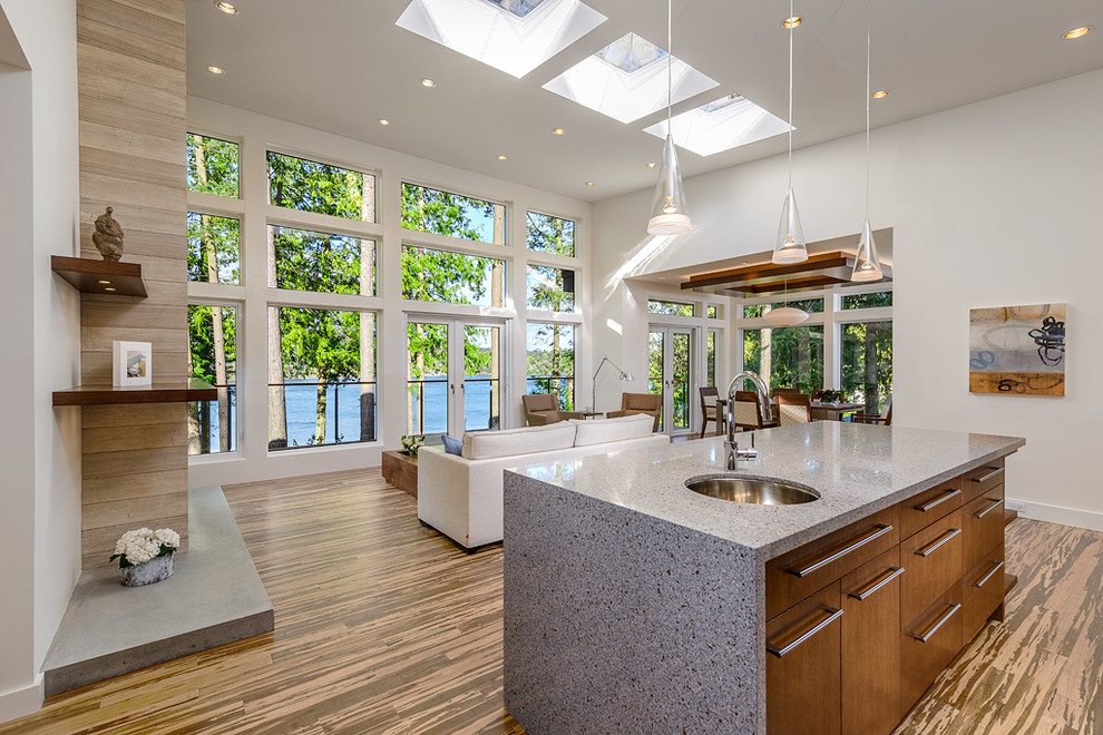 Photo of a contemporary galley open plan kitchen in Vancouver with flat-panel cabinets and medium wood cabinets.