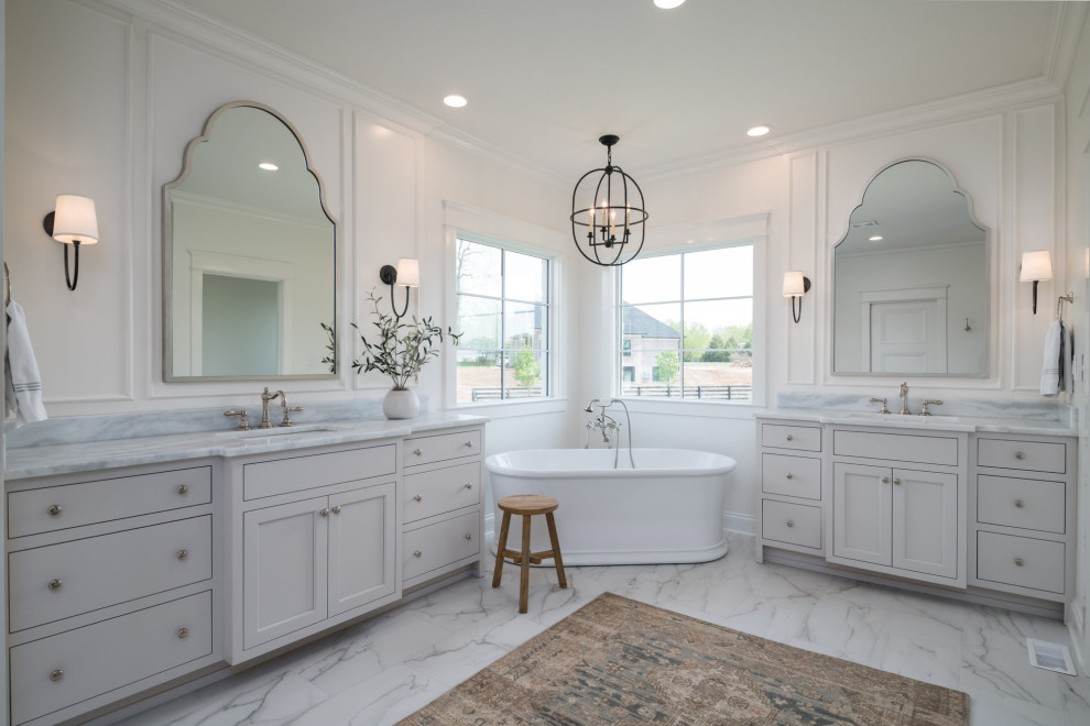 Photo of a large transitional master bathroom in Other with flat-panel cabinets, white cabinets, a freestanding tub, an alcove shower, white tile, porcelain tile, white walls, porcelain floors, an undermount sink, marble benchtops, white floor, a hinged shower door, white benchtops, an enclosed toilet, a single vanity and a built-in vanity.