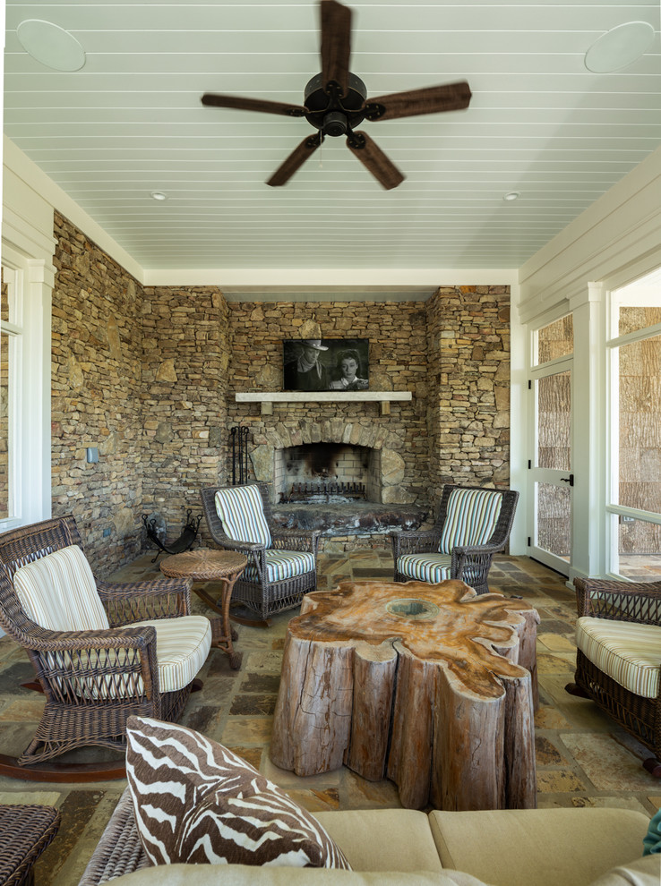 Large country sunroom in Birmingham with a standard fireplace and a stone fireplace surround.