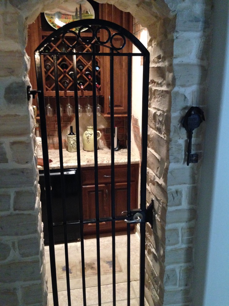 This is an example of a small country wine cellar in Houston with ceramic floors and diamond bins.