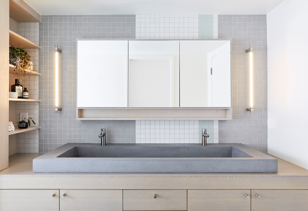 Inspiration for a mid-sized modern master bathroom in Portland with flat-panel cabinets, light wood cabinets, multi-coloured tile, mosaic tile, white walls, mosaic tile floors, a trough sink, wood benchtops, multi-coloured floor and grey benchtops.