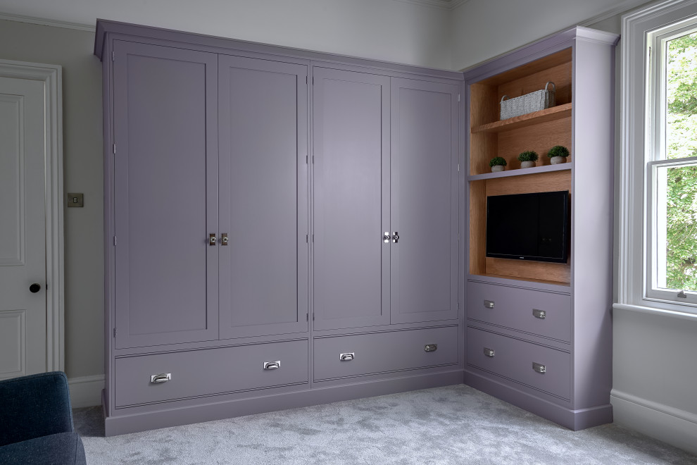 Design ideas for a medium sized modern gender neutral wardrobe in West Midlands with shaker cabinets, carpet and grey floors.