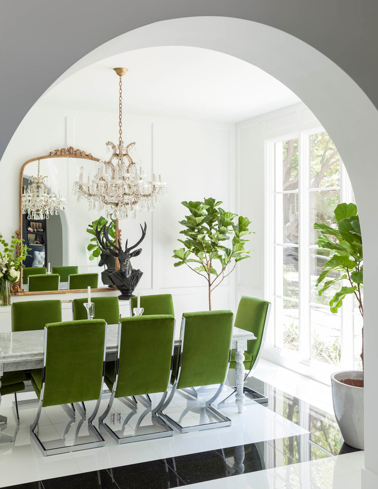 Eclectic separate dining room in Dallas with white walls and marble floors.