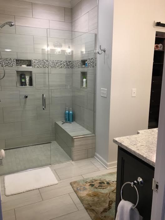 Inspiration for a mid-sized transitional master gray tile and porcelain tile porcelain tile and beige floor alcove shower remodel with recessed-panel cabinets, dark wood cabinets, beige walls, an undermount sink, granite countertops and a hinged shower door