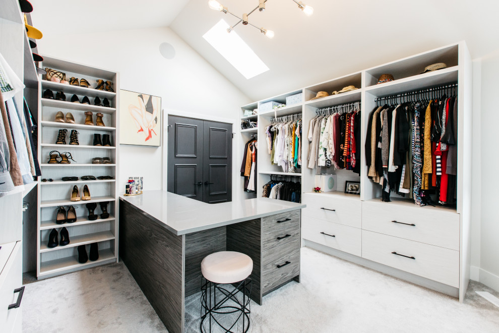 Design ideas for a transitional walk-in wardrobe in Other with flat-panel cabinets, white cabinets, carpet, grey floor and vaulted.