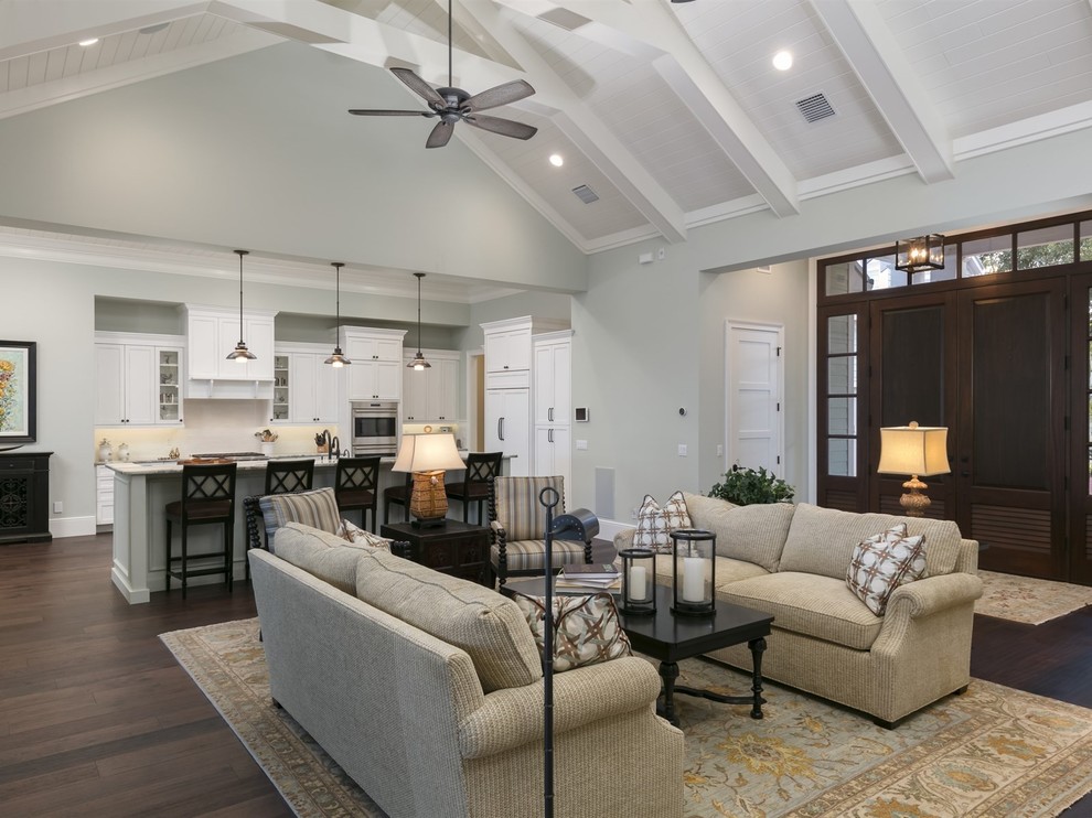 Design ideas for a large beach style open concept family room in Orlando with grey walls, dark hardwood floors, a standard fireplace, a tile fireplace surround and brown floor.