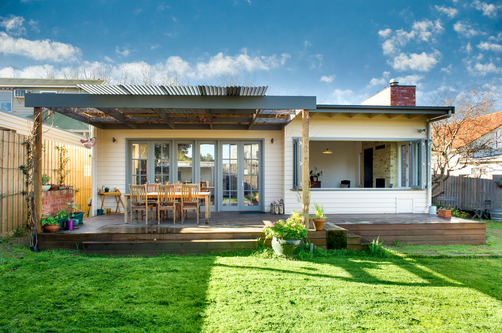 Design ideas for a large contemporary backyard deck in Melbourne with a pergola.