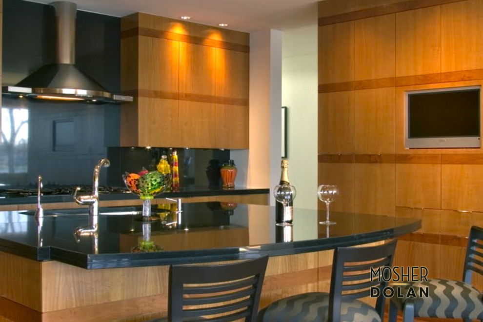 Single-wall medium tone wood floor eat-in kitchen photo in Detroit with an integrated sink, flat-panel cabinets, light wood cabinets, black backsplash and an island