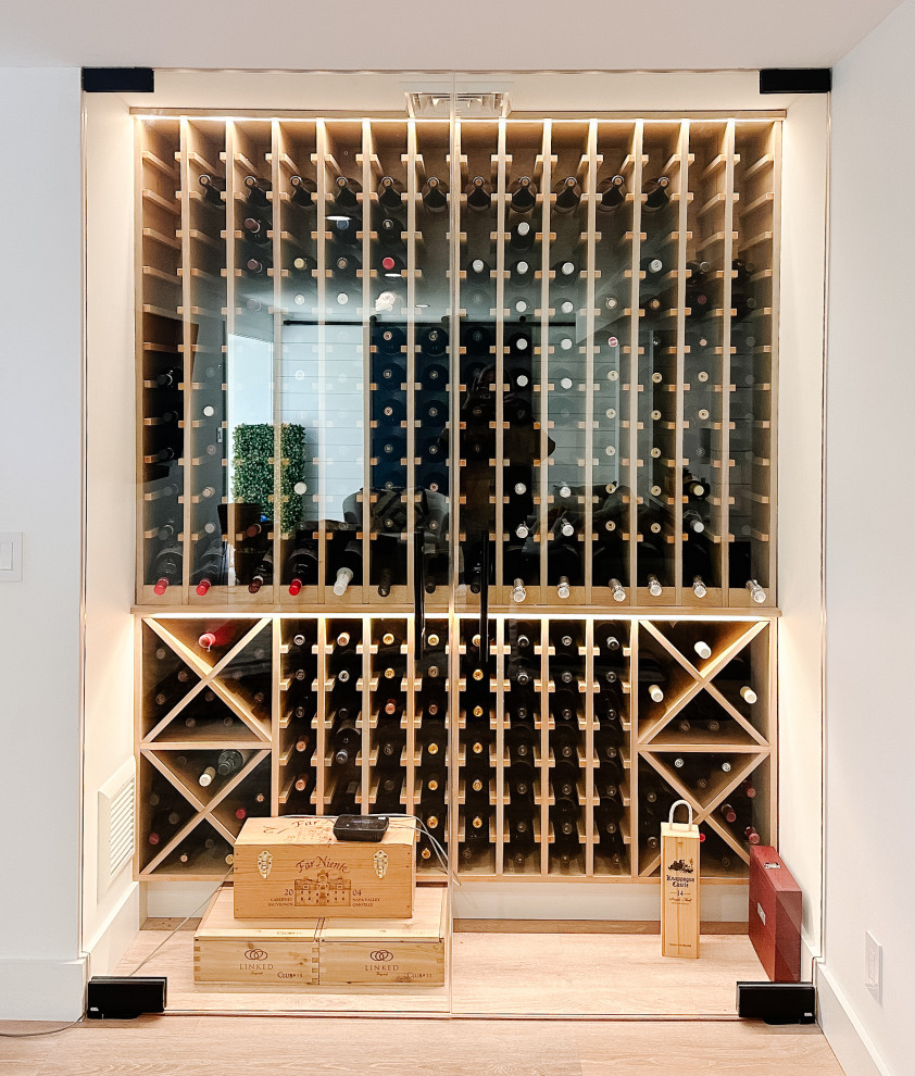 Inspiration for a small beach style wine cellar in New York with vinyl floors, diamond bins and brown floor.