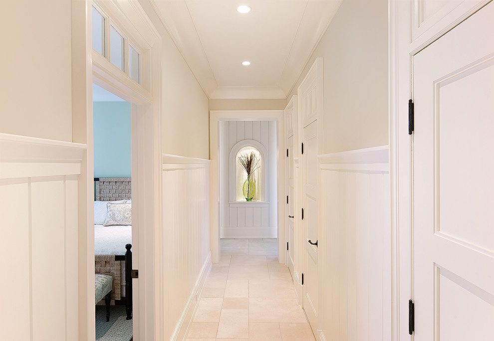 Inspiration for a beach style hallway in Charleston with white walls and travertine floors.