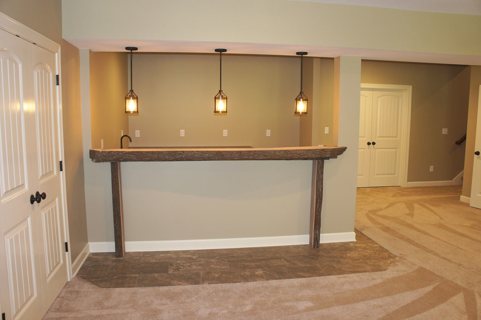Home design - mid-sized rustic underground carpeted and beige floor home design idea in Indianapolis with beige walls