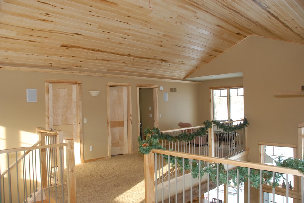 Hallway - large rustic carpeted and beige floor hallway idea with beige walls