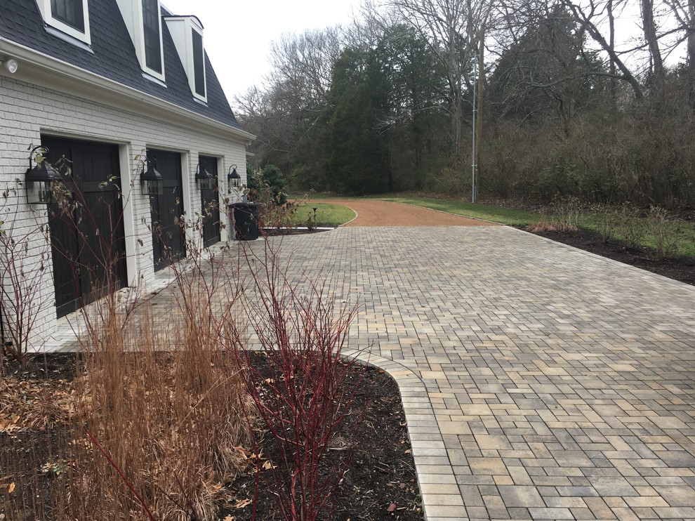 This is an example of a large traditional front yard full sun driveway in Nashville with concrete pavers.